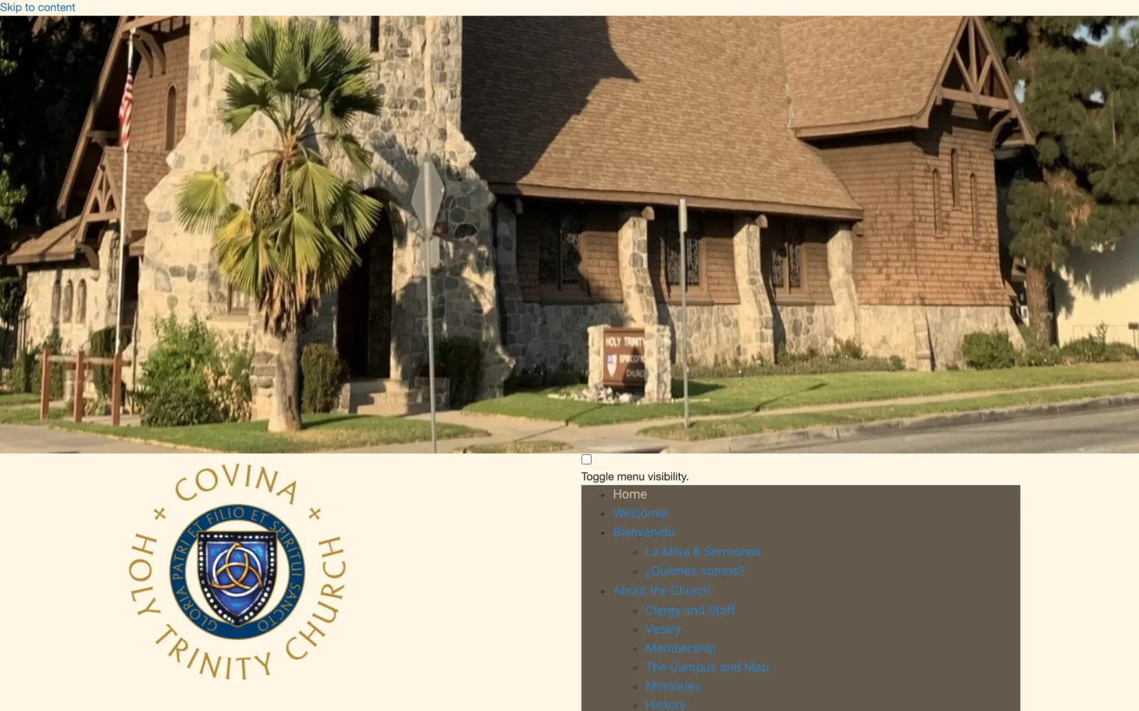 The old Holy Trinity Covina homepage on WordPress: the stone church building above a dated, cluttered navigation menu